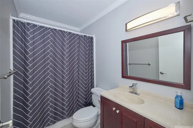 a bathroom with a sink mirror vanity and toilet