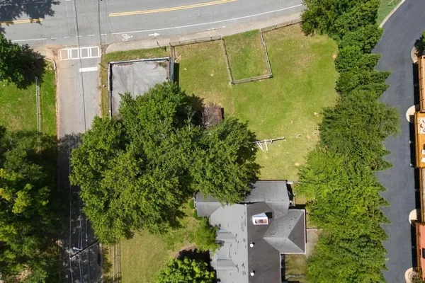 an aerial view of a house with a yard