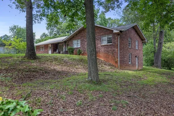 a view of a house with yard and a tree
