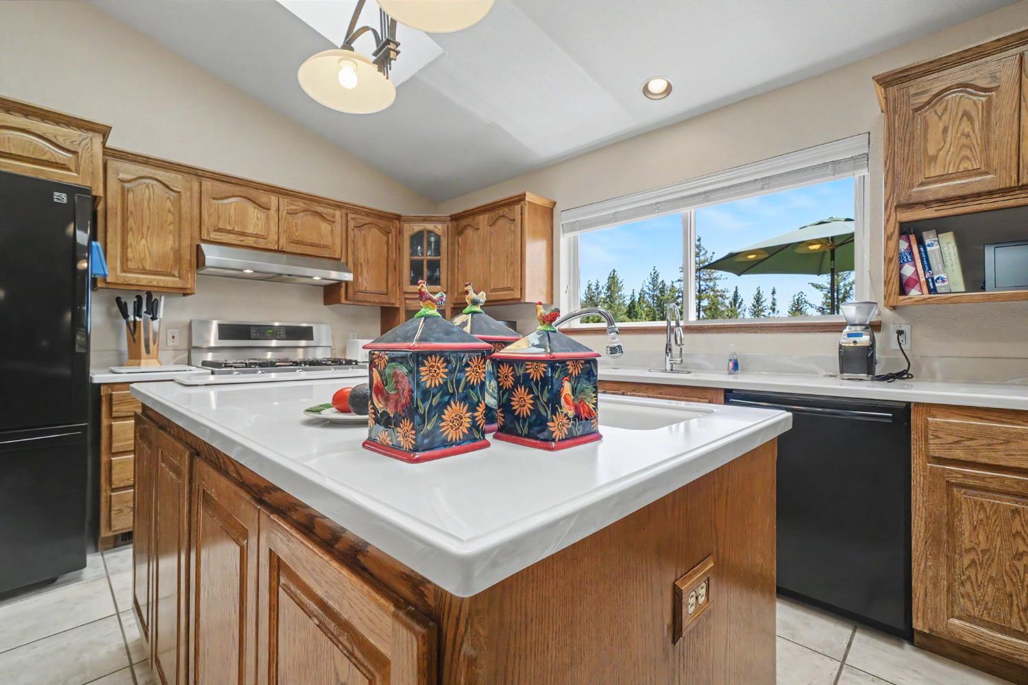 18299 West Clinton Road Jackson, CA 95642 - Photo 25 of 56 a kitchen with a sink a stove and a refrigerator