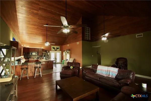 a living room with lots of furniture and a chandelier
