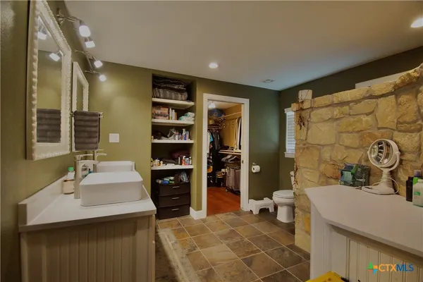 a bathroom with a double vanity sink toilet and shower