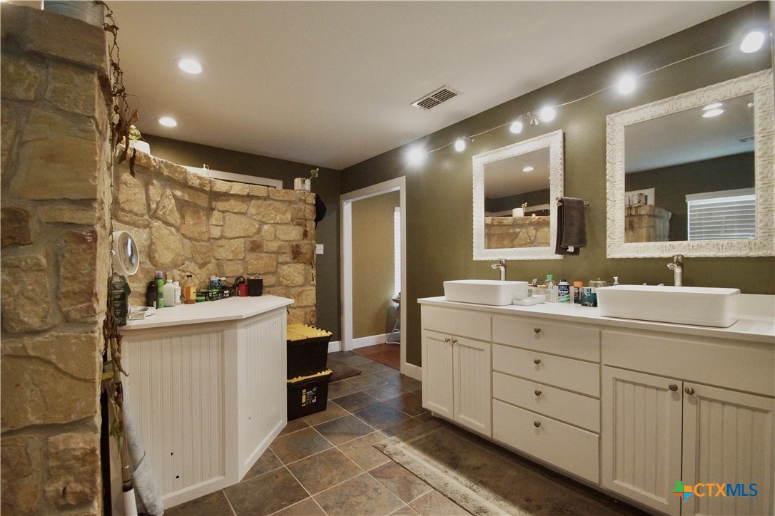 27 Stehle Road Victoria, TX 77905 - Photo 27 of 34 a bathroom with a double vanity sink toilet and shower
