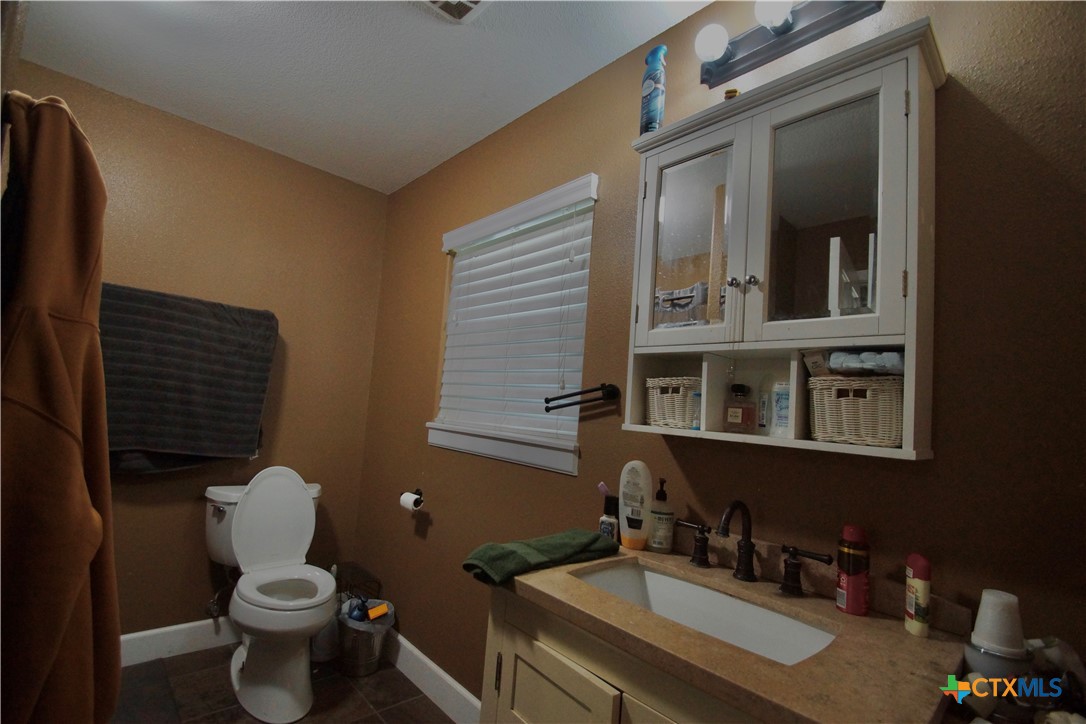 27 Stehle Road Victoria, TX 77905 - Photo 30 of 34 a bathroom with a granite countertop toilet sink and mirror