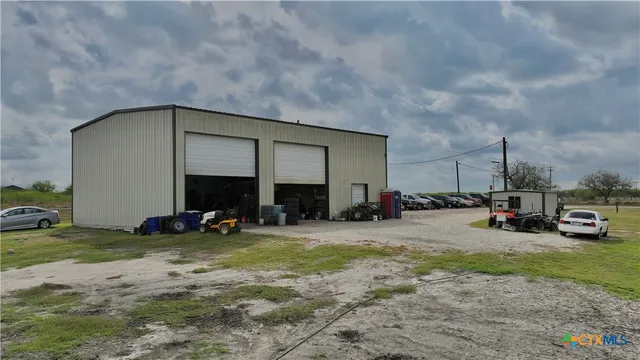 a view of a house with outdoor space and a car parked in front of it