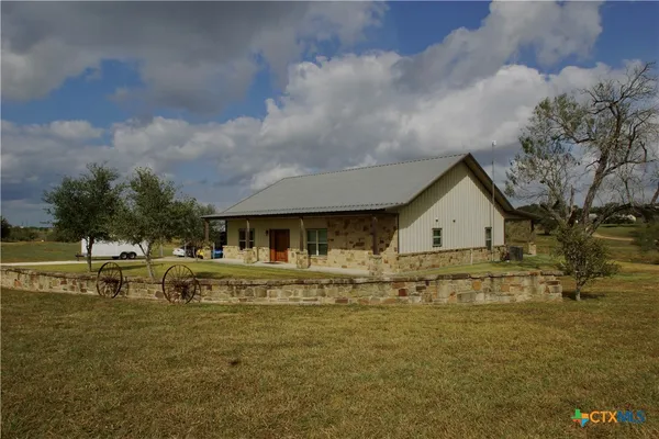 a view of house with outdoor space and swimming pool