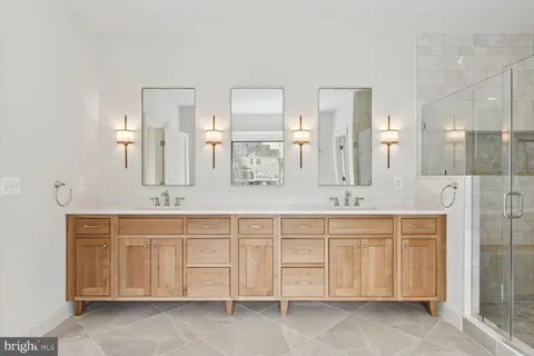 a bathroom with a double vanity sink and a mirror