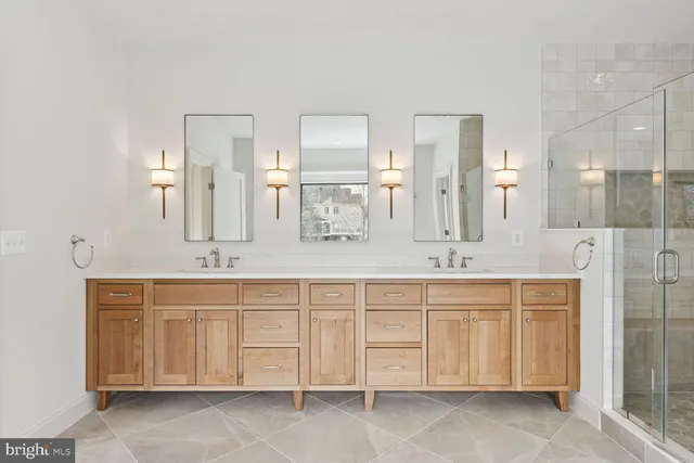 a bathroom with a double vanity sink and a mirror