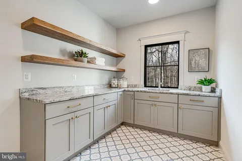 a kitchen with granite countertop white cabinets and white appliances