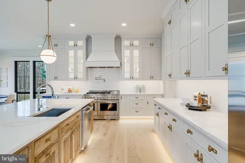 a kitchen with kitchen island white cabinets and appliances