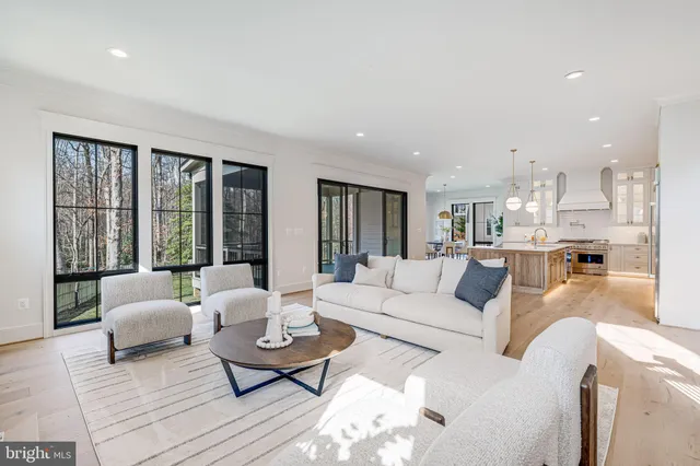 a living room with furniture and large windows