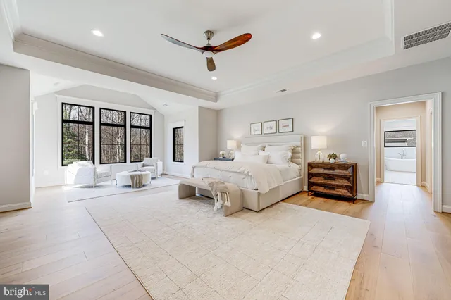 a spacious bedroom with a large bed and a large window