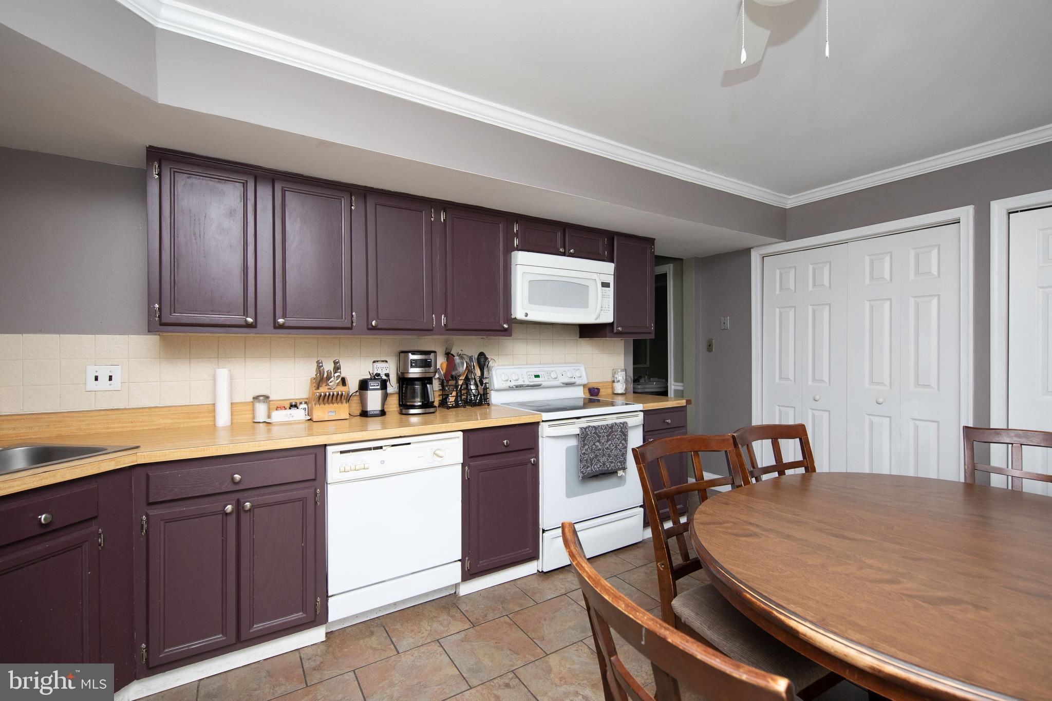 2086 Fort Bevon Road Harleysville, PA 19438 - Photo 11 of 24 a kitchen with a sink a stove cabinets and wooden floor