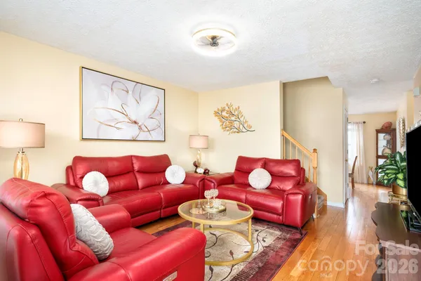 a living room with furniture and wooden floor