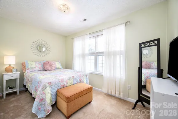 a bedroom with a bed chair and a window