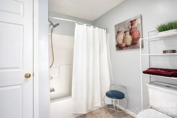 a bathroom with a shower and a toilet