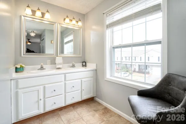 a spacious bathroom with 2 sink tub and a mirror