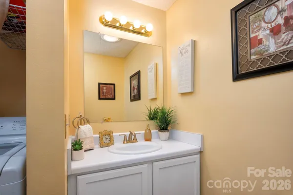 a bathroom with a sink a mirror and vanity