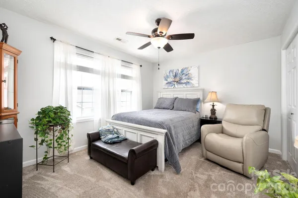a bedroom with furniture and a large window
