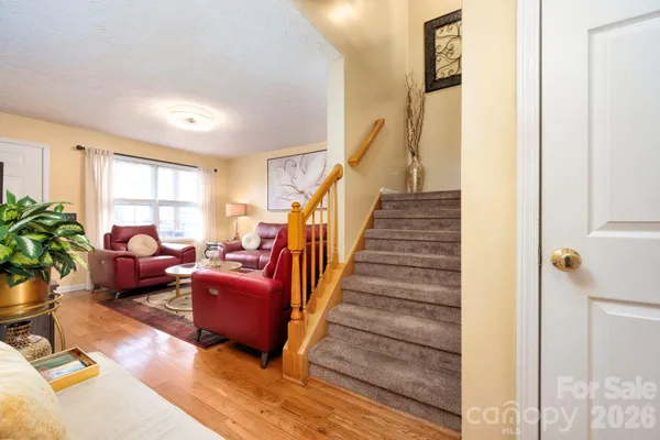 a living room with furniture windows and wooden floor