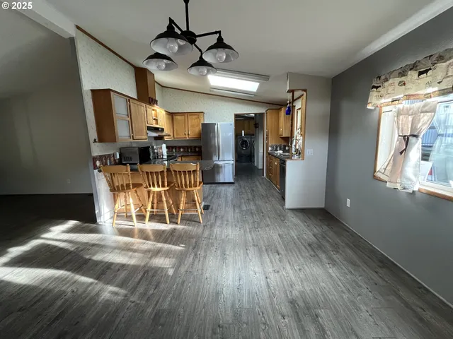 a kitchen with stainless steel appliances granite countertop sink stove top oven and cabinets