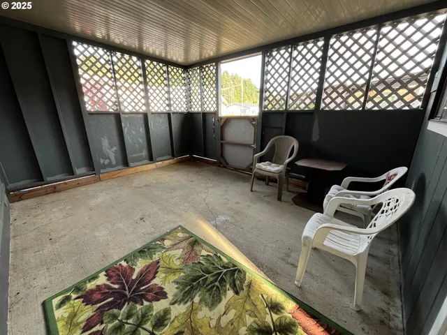 a backyard of a house with barbeque oven table and chairs