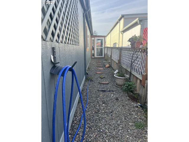 a view of an empty room with a window and a fireplace