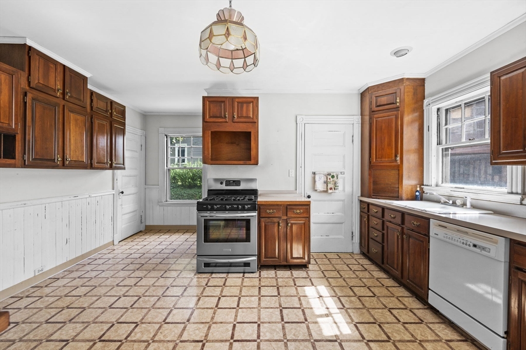366 Cabot Street Beverly, MA 01915 - Photo 11 of 42 a kitchen with stainless steel appliances a stove sink and cabinets
