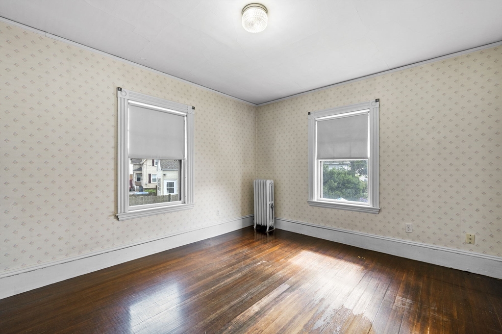 366 Cabot Street Beverly, MA 01915 - Photo 20 of 42 a view of an empty room with wooden floor and a window