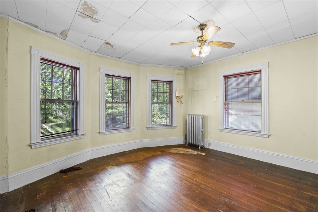 366 Cabot Street Beverly, MA 01915 - Photo 21 of 42 a view of an empty room with wooden floor and a window