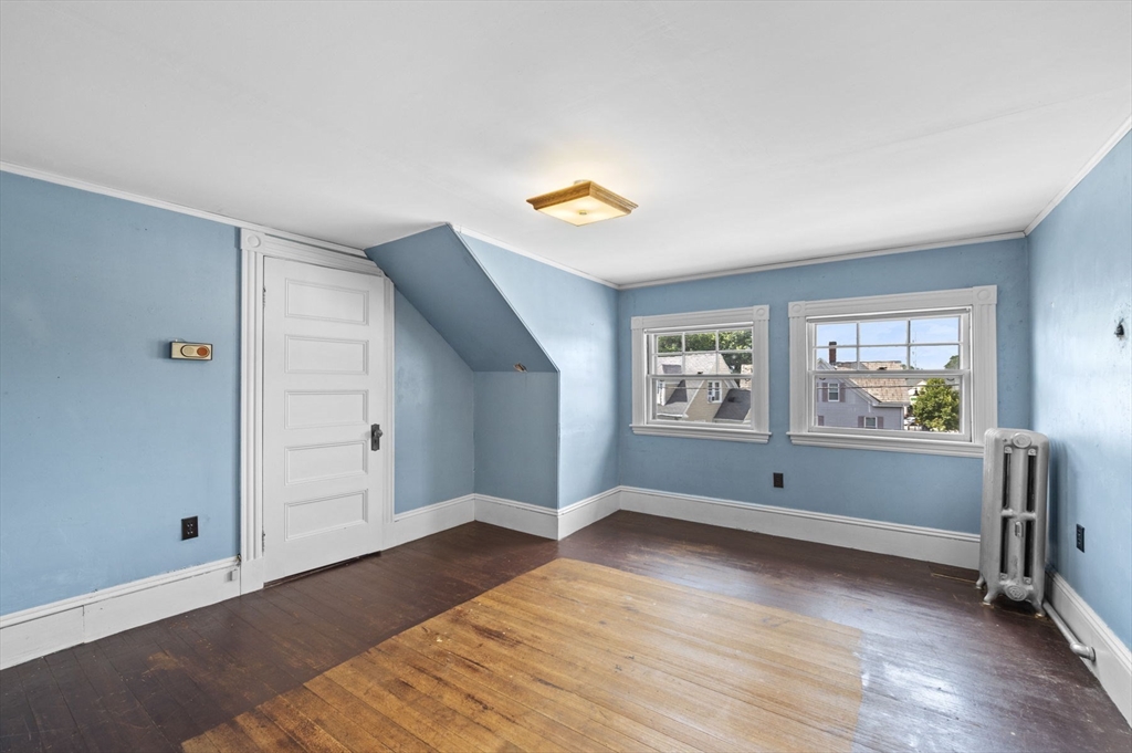 366 Cabot Street Beverly, MA 01915 - Photo 22 of 42 an empty room with window and wooden floor