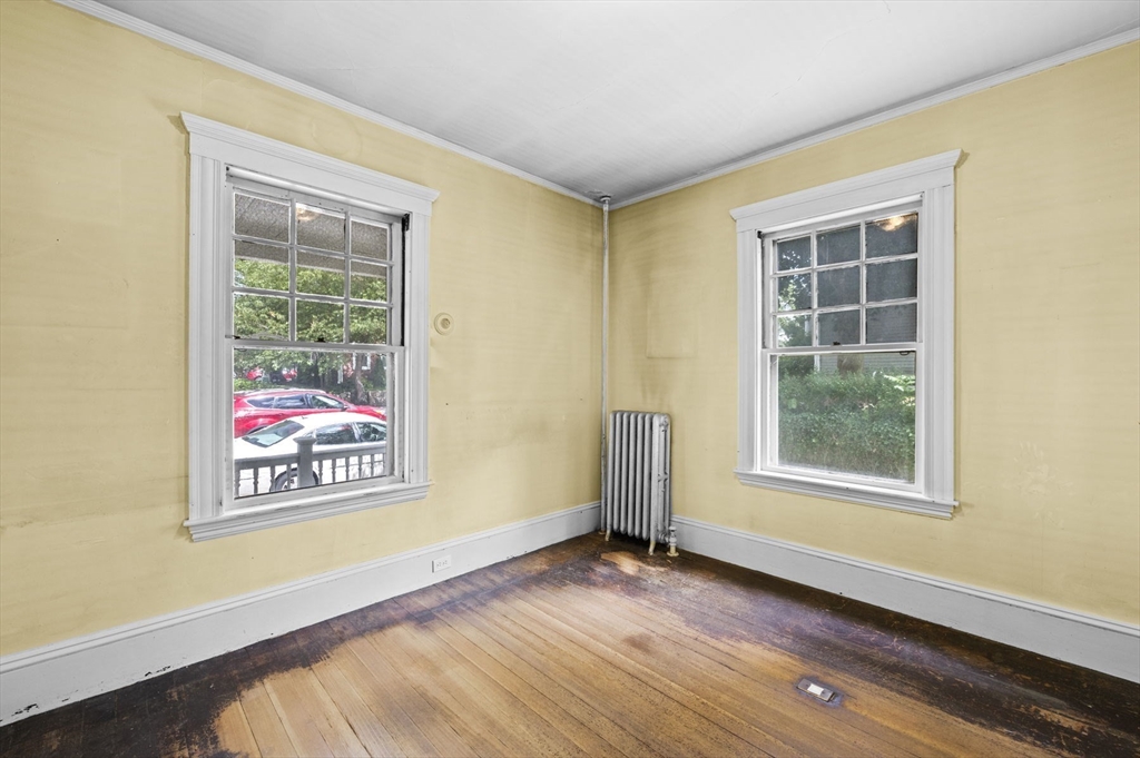 366 Cabot Street Beverly, MA 01915 - Photo 23 of 42 an empty room with wooden floor and windows