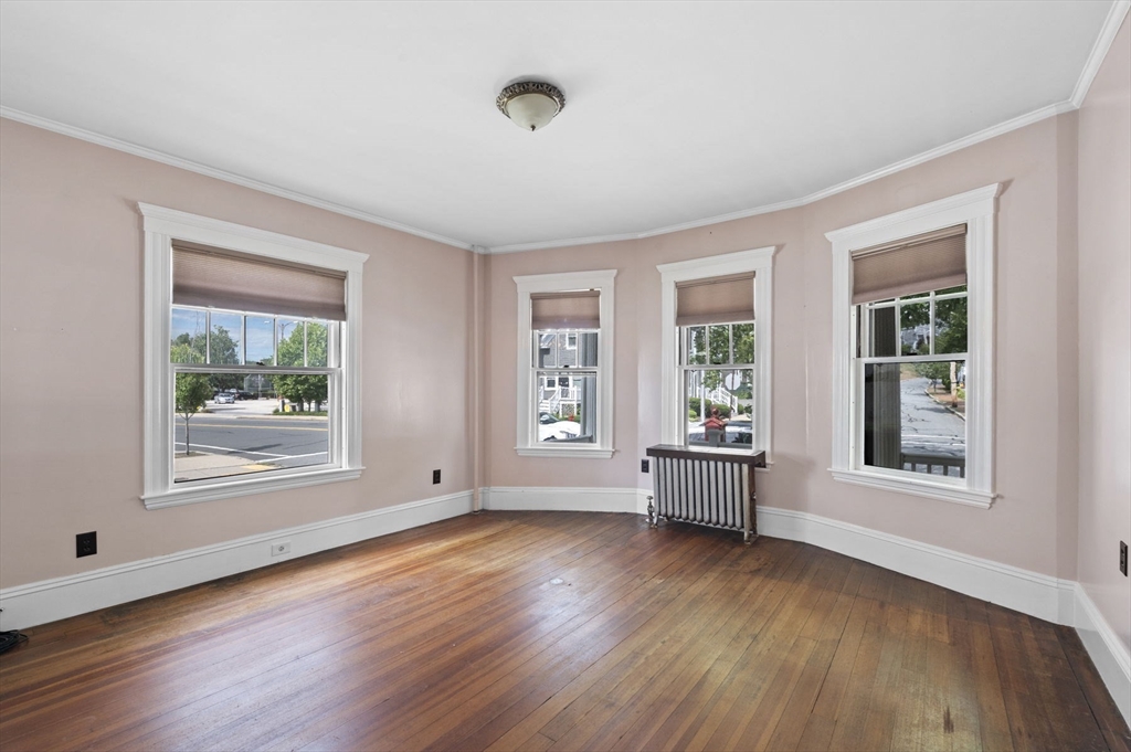 366 Cabot Street Beverly, MA 01915 - Photo 32 of 42 a view of an empty room with wooden floor and a window