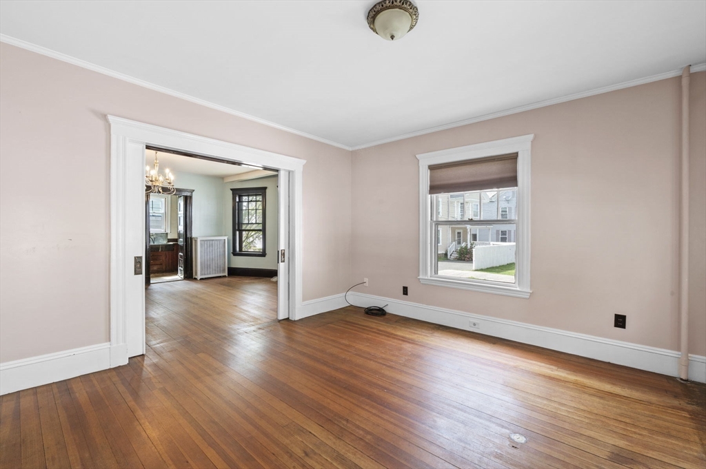 366 Cabot Street Beverly, MA 01915 - Photo 33 of 42 an empty room with wooden floor and windows