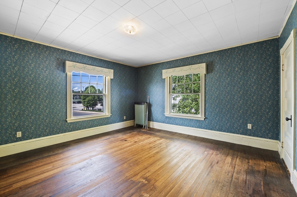 366 Cabot Street Beverly, MA 01915 - Photo 34 of 42 a view of an empty room with wooden floor and a window