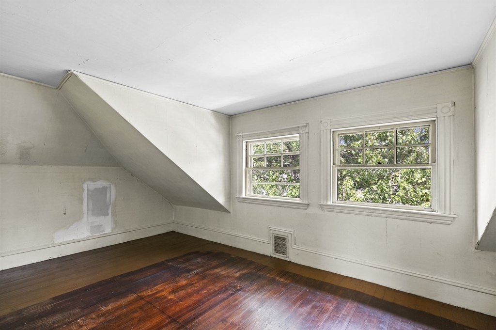 366 Cabot Street Beverly, MA 01915 - Photo 36 of 42 a view of an empty room with wooden floor and a window