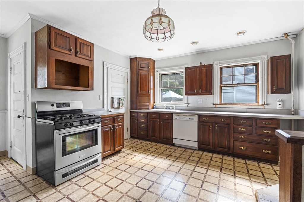 366 Cabot Street Beverly, MA 01915 - Photo 10 of 42 a kitchen with stainless steel appliances granite countertop a stove a sink and a microwave
