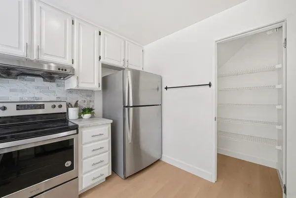 a kitchen with cabinets and stainless steel appliances