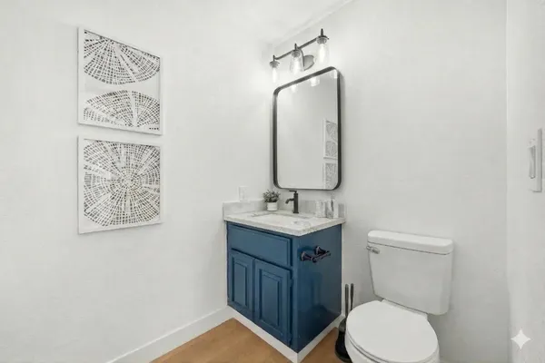 a bathroom with a toilet a sink and mirror