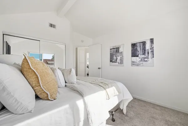 a bedroom with a bed and a lamp