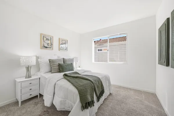a bedroom with a bed and a window