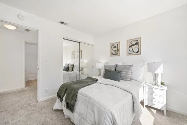 a bedroom with a bed and a lamp
