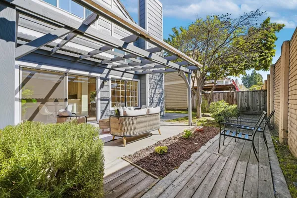 a view of house with patio outdoor seating and wooden floor