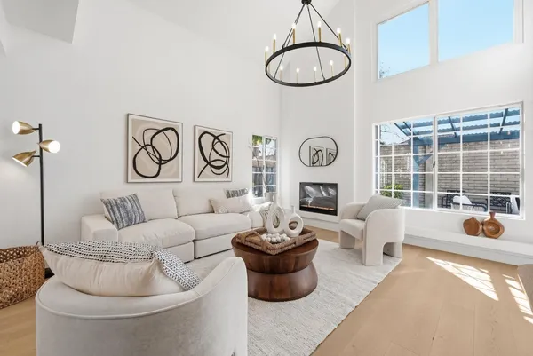a living room with fireplace furniture and a large window