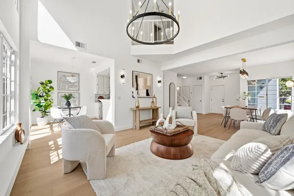a living room with furniture and a chandelier