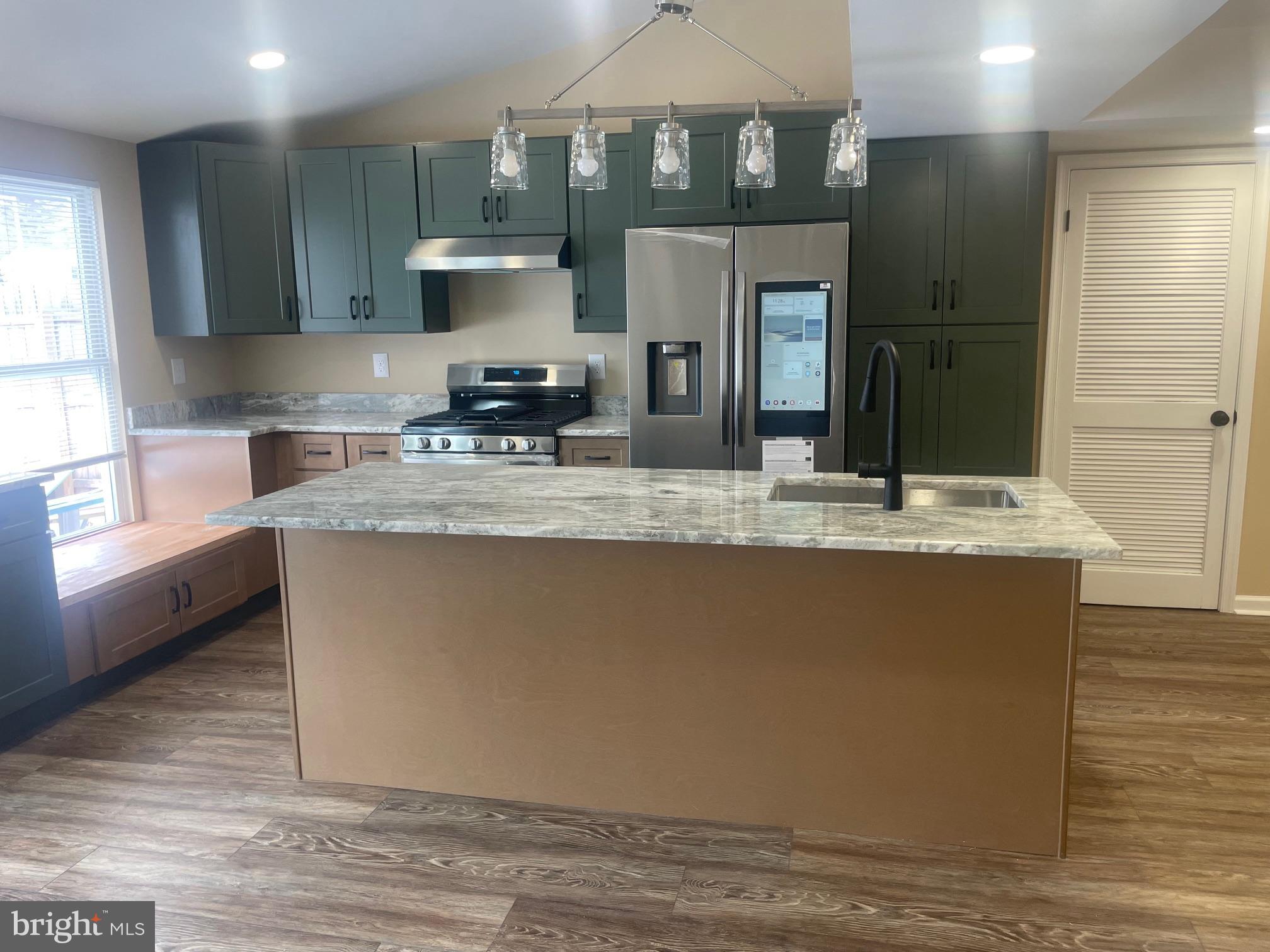 3 Farmhouse Court Sicklerville, NJ 08081 - Photo 7 of 24 a kitchen with kitchen island granite countertop a stove a sink and a refrigerator