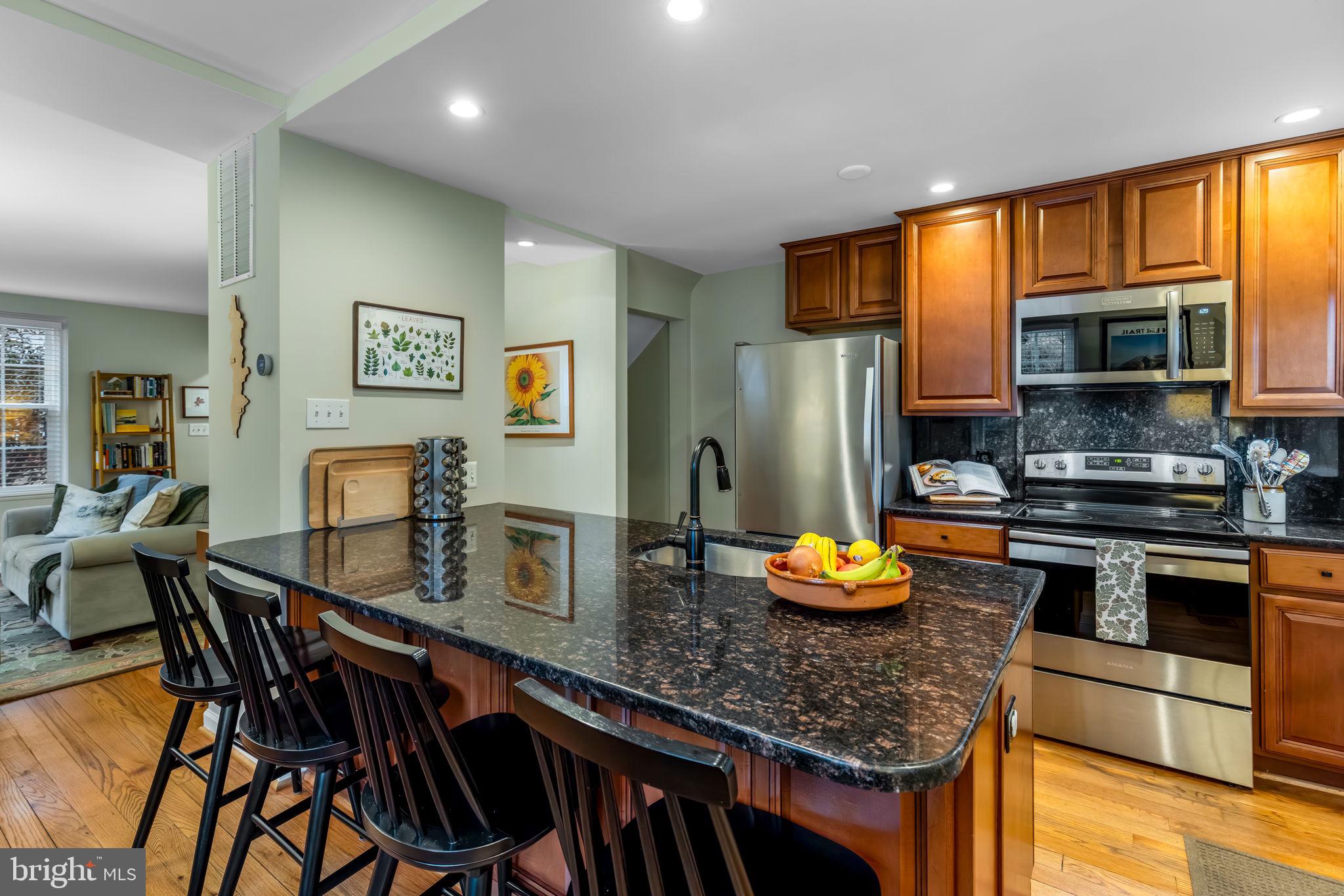 4225 32nd Road South Arlington, VA 22206 - Photo 2 of 36 a kitchen with stainless steel appliances granite countertop a stove refrigerator a microwave oven a sink with island and chairs