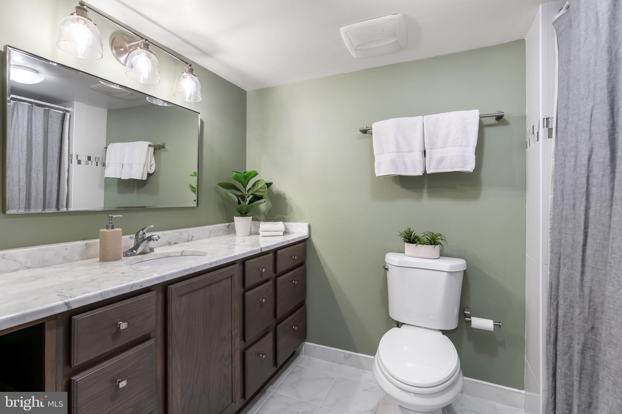 4225 32nd Road South Arlington, VA 22206 - Photo 30 of 36 a bathroom with a toilet sink vanity granite and mirror