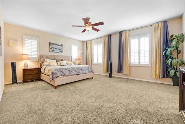 a spacious bedroom with a bed and a window