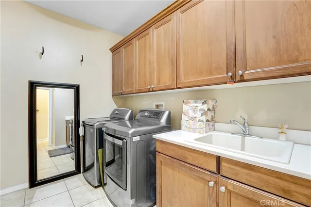 a utility room with sink dryer and washer